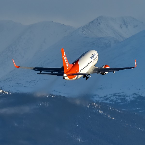Aircraft - taking off with mountains in background