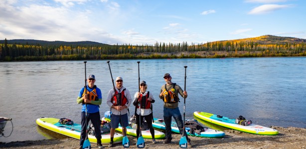 Group of paddle boarders in front of Yukon River
