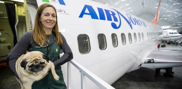Pug with Dr. Oakley in front of plane.
