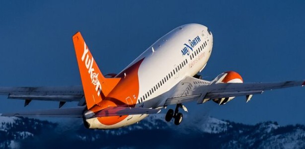 An Air North plane flying over the mountains