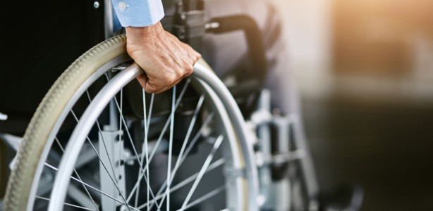 Person pushing themselves in a wheelchair