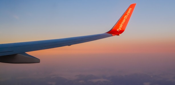 Winglet of one of Air North's Boeing 737-800s as sunset colours cast pastel hues in the sky.
