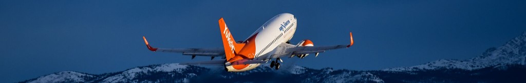 An Air North plane flying over the mountains