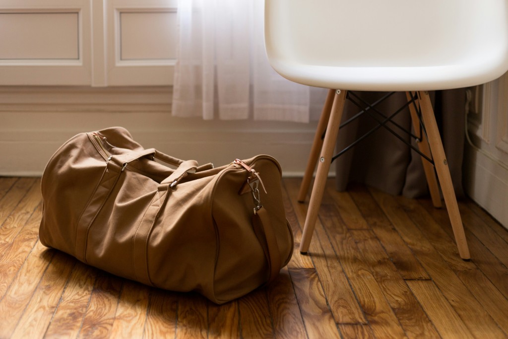 Baggage next to chair in sunlight